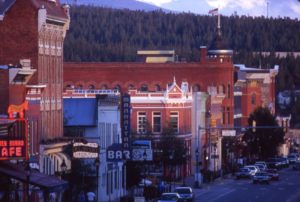 View of Leadville's historic main street buildings with forest and mountains in the background